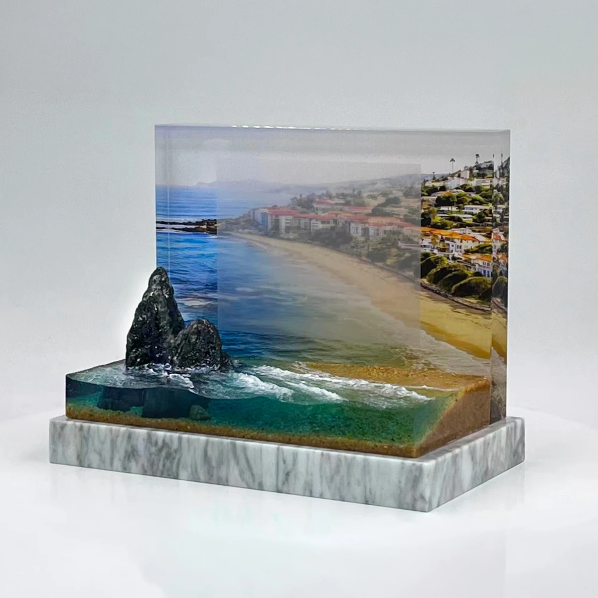 A coastal scene with a dimensional shoreline brings the setting into the design.